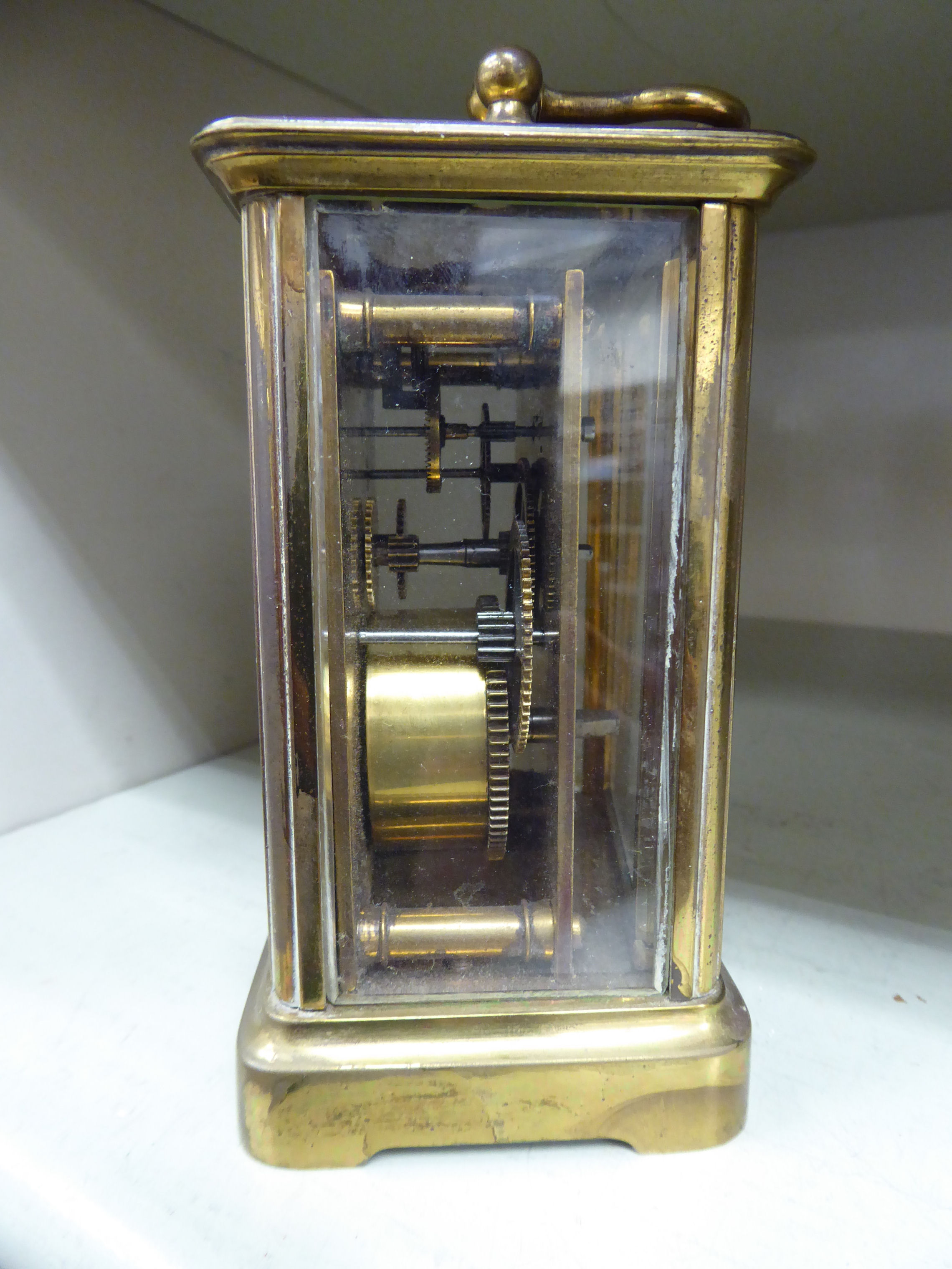 A mid 20thC brass cased carriage timepiece with bevelled glass panels and a folding top handle; - Image 2 of 2