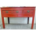 A modern Chinese lacquered red elm traditional side table with a mitred top,