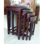 A modern nesting set of four Chinese fruitwood occasional tables,