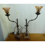 A pair of early 20thC French bronze table lamps, each with an adjustable tubular stem,