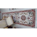 A Persian silk and wool runner with three medallions on a beige and red ground 122'' x 35''