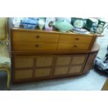 A modern teak two section sideboard with four drawers,