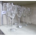 A set of four John Rocha designed for Waterford pedestal wine glasses with thumb moulded ornament;