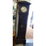 A 1930s stained oak longcase clock; the movement faced by a silvered Arabic dial,