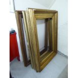 Three similar Victorian and later moulded gilt and other picture frames largest 22'' x 40''