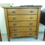 A modern honey coloured hardwood, five drawer dressing chest with iron grab handles,