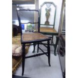 An early 20thC child's Japanese black lacquered bar back child's chair,