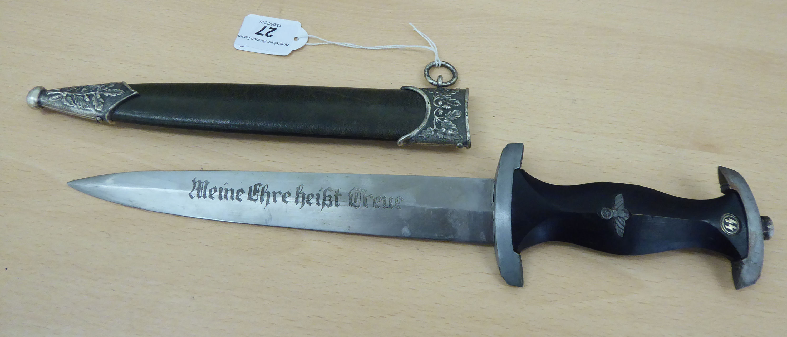 A replica SS dagger, the carved, ebonised wooden handgrip moulded with emblems, the 8. - Image 2 of 2
