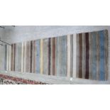 A modern striped woollen rug in tones of blue,