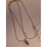 A 14ct white gold tanzanite and diamond pendant,