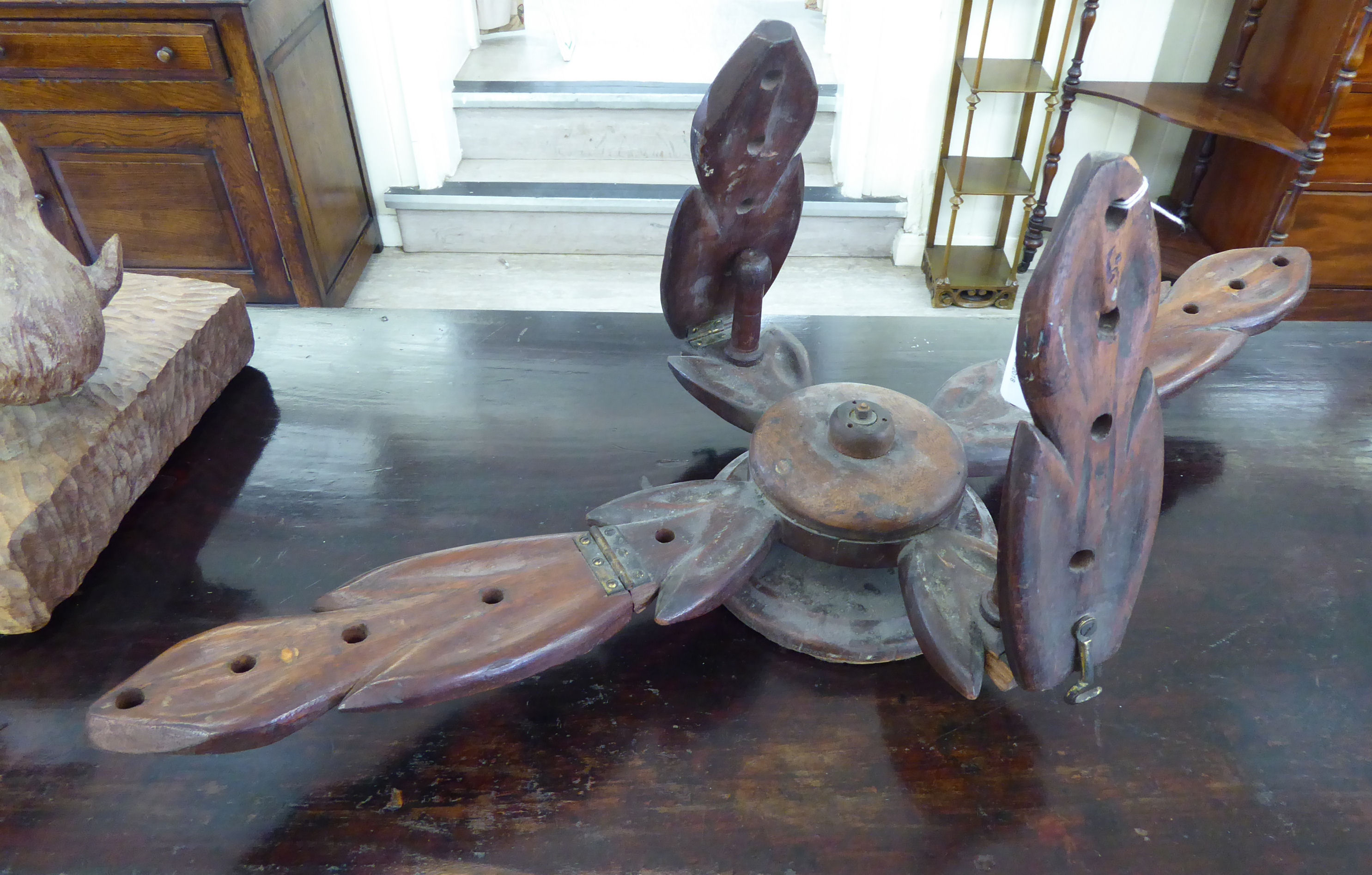 A late 19thC mahogany wool winder of foliate,