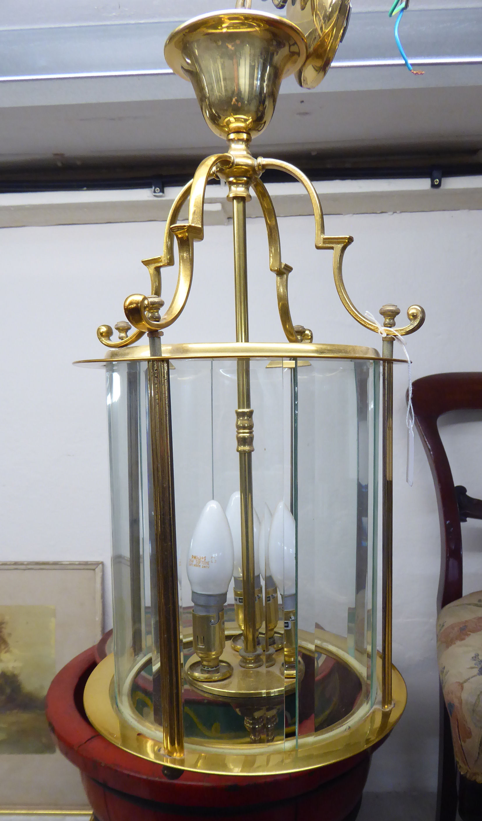 A modern Georgian style brass framed hanging lantern light with bevelled glass panels and