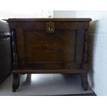 An early 20thC crossbanded and burr walnut finished magazine rack with a fall flap,
