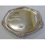 A silver salver with a raised gadrooned and shell cast border,