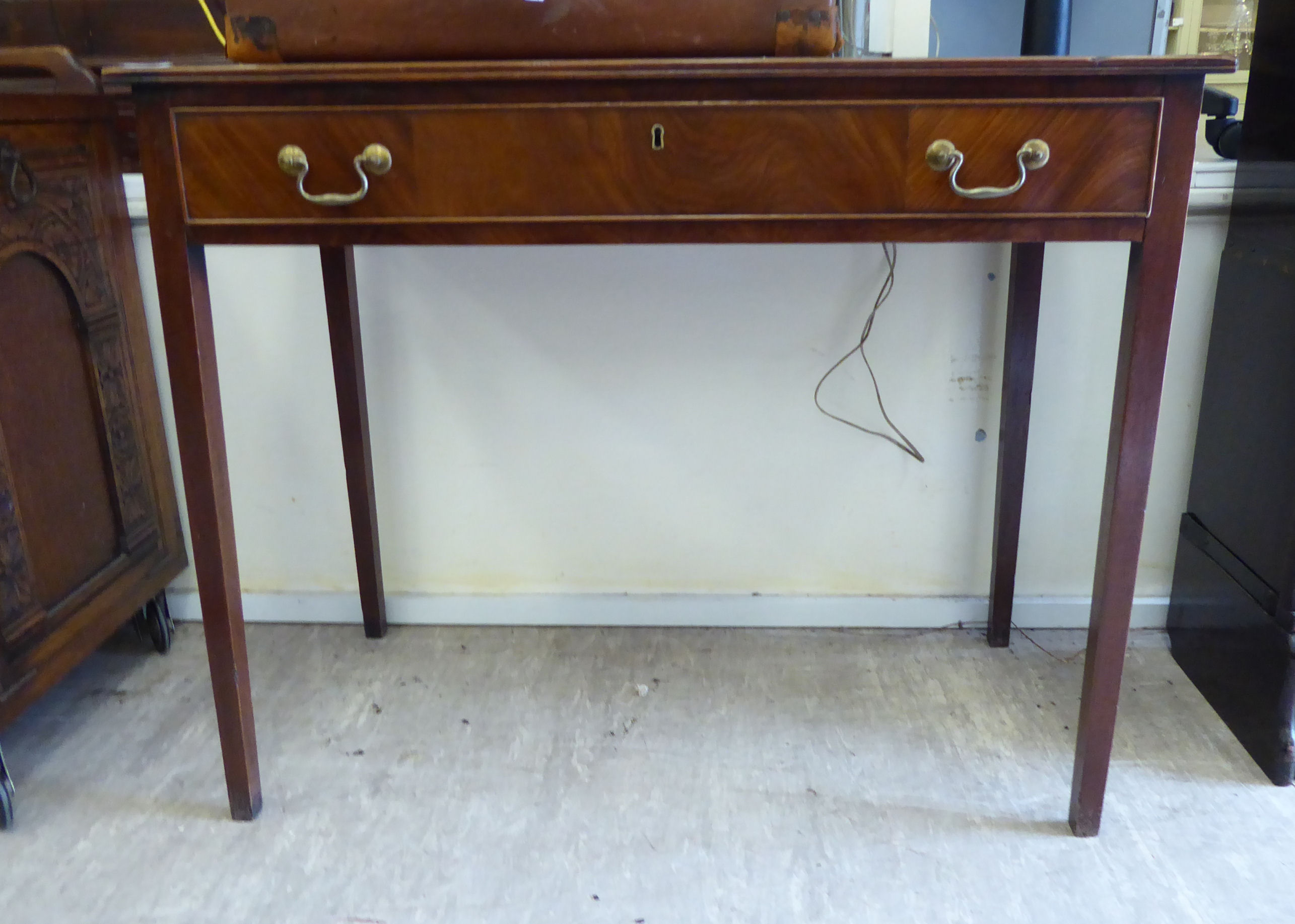 An early 19thC satinwood inlaid mahogany single drawer side table, raised on square,