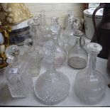 Fifteen dissimilar 20thC glass decanters of various sizes and form most with stoppers BSR