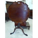 A George III mahogany tip-top table with a raised piecrust border,