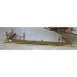 A mid 20thC reproduction of a Georgian brass extending fire curb with C-scrolled,
