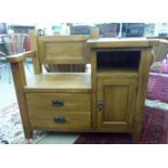 A modern light oak telephone seat with two drawers bedside, an open shelf and panelled door,