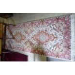 A Persian silk and wool runner with three medallions on a beige and pink ground 114'' x 34''