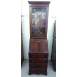 A modern Georgian style mahogany finished bureau bookcase with a glazed door,