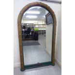 A modern pier glass, the round arched bevelled plate,