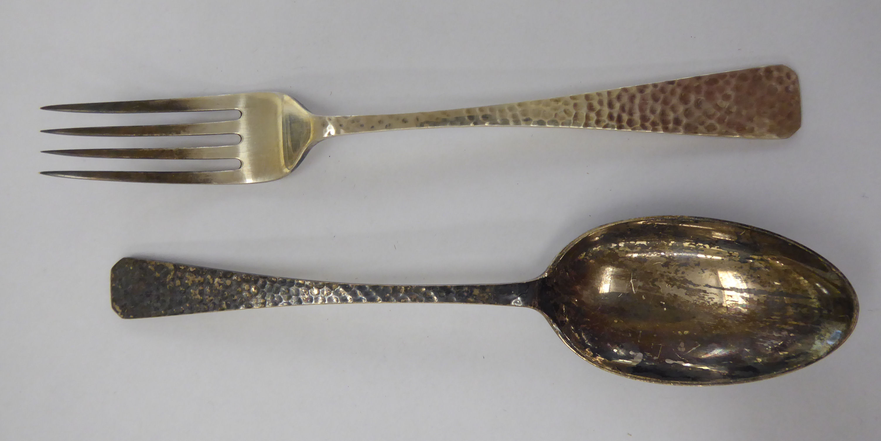 A two piece spot-hammered silver Christening set, a fork and spoon, in a fabric lined,