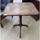 An early 20thC stained oak pedestal table, the planked top with canted corners,