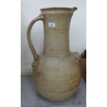 A studio pottery ewer bears an indistinct stamp 23''h CA