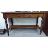 An Edwardian mahogany dressing table with two frieze drawers, raised on ring turned,