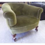 An early 20thC tub chair, the part green upholstered back,