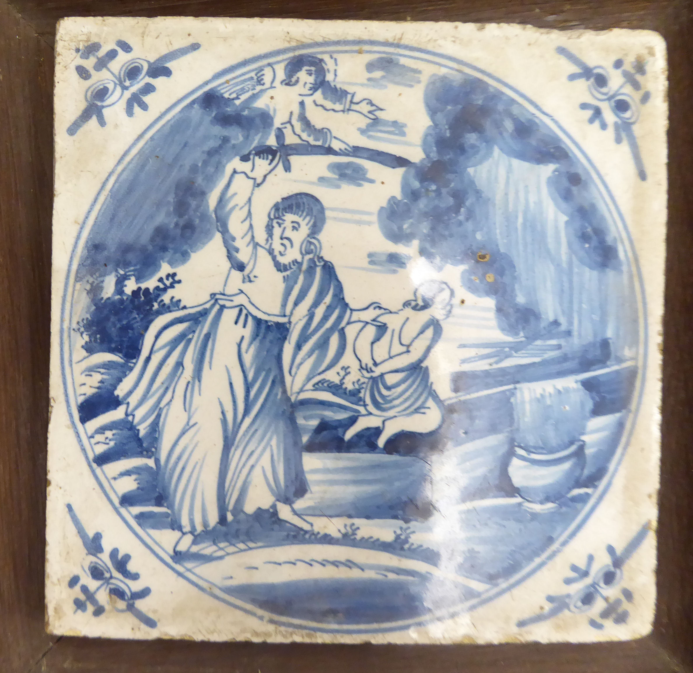 An 'antique' Dutch pottery tile, decorated in blue and white, in an oak frame 4.