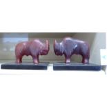A pair of amber coloured Bakelite bookends, fashioned as bisons,