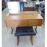 A 1970s teak finished four drawer dressing table,