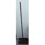 An Edwardian stained oak and cast iron mounted Express carpet sweeper with a turned handle