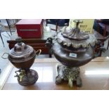 Two similar late Victorian cast brass and copper samovars, one on an elevated bracket plinth,