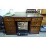 An early 20thC mahogany nine drawer, twin pedestal desk,