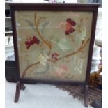 An early 20thC mahogany finished, framed firescreen,