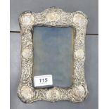 An Art Nouveau silver mounted photograph frame, decorated with cherubs and foliage,