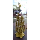 A modern cast brass cotton reel stand with a pin cushion finial and four tiers accommodating