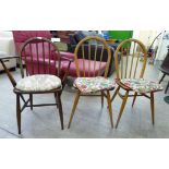 Ercol furniture: to include a pair of spindle back chairs, the solid seats raised on turned,