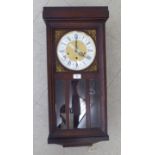 A mid 20thC oak cased wall clock;