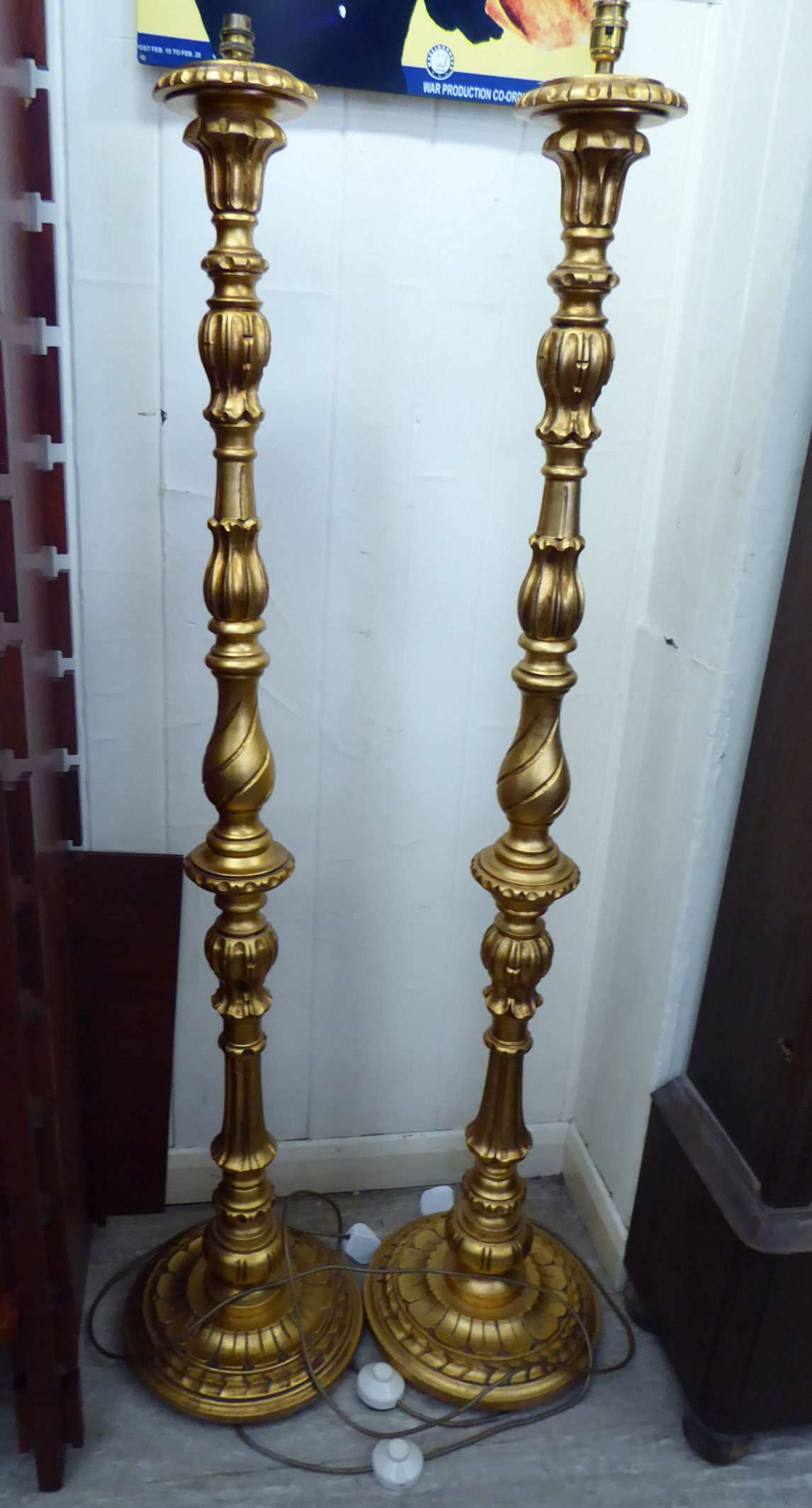 A pair of modern gilded softwood standard lamps, each with a carved demi-fluted column,
