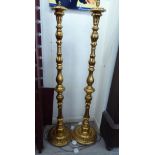 A pair of modern gilded softwood standard lamps, each with a carved demi-fluted column,