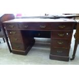 A late Victorian walnut nine drawer twin pedestal desk,