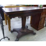 A William IV rosewood card table, the rotating, foldover top raised on a tapered column,