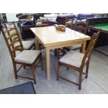 A modern light oak draw leaf dining table,