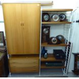 A 1970s Ladderax style teak modular wall unit, the metal frame supporting a compactum,