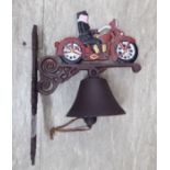 A cast iron door bell, fashioned as a man on a motorbike,