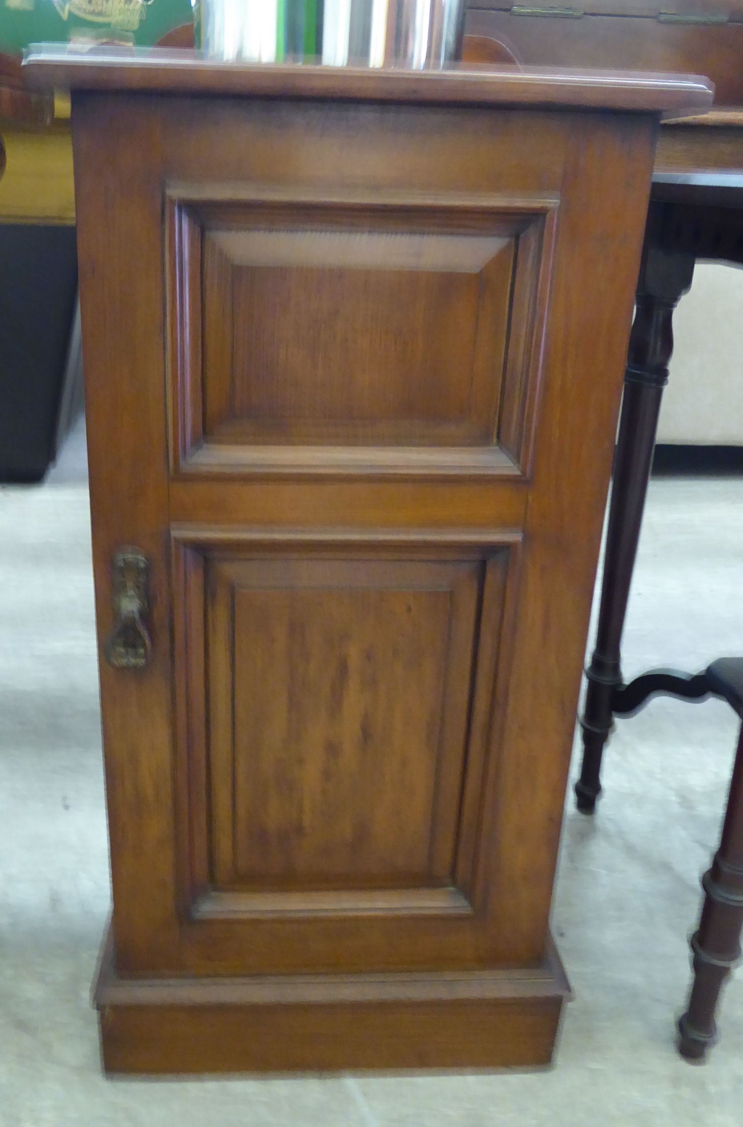A late Victorian oak bedside cabinet with a single door,